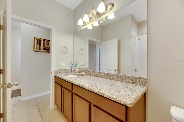 bathroom featuring toilet, walk in shower, vanity, and tile patterned floors