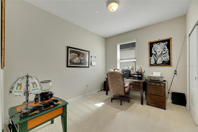 home office featuring a textured ceiling and light colored carpet