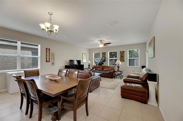 dining area featuring ceiling fan with notable chandelier and light tile patterned floors