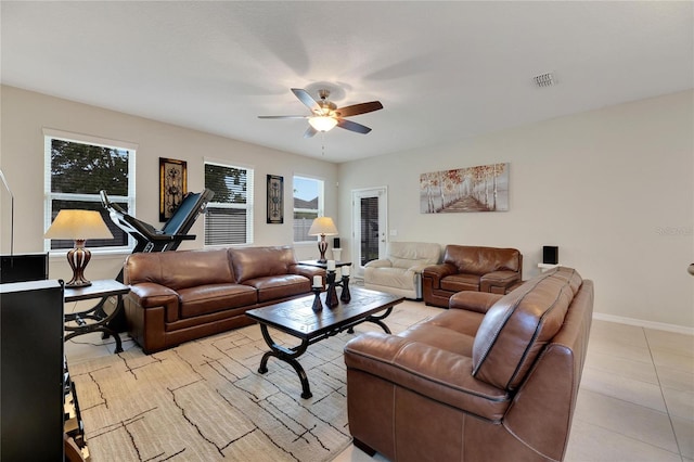 living room with light tile patterned floors and ceiling fan