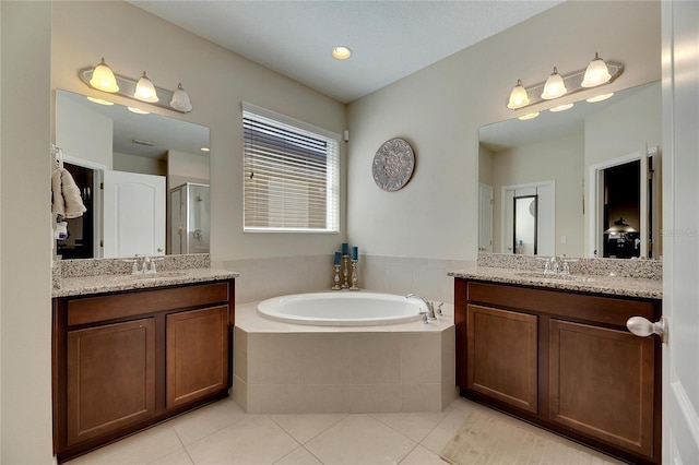 bathroom featuring vanity, plus walk in shower, and tile patterned floors