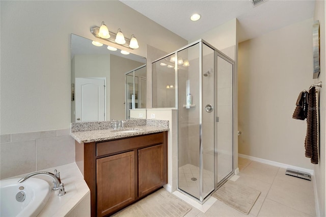 bathroom with vanity, shower with separate bathtub, and tile patterned floors