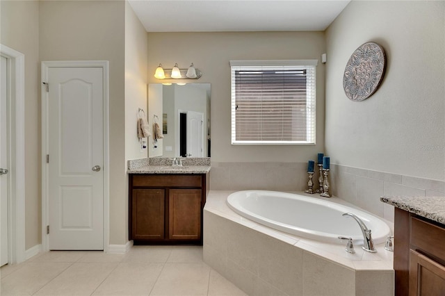 bathroom with vanity, tile patterned floors, and tiled tub