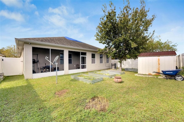 back of property with a storage unit, a yard, and a sunroom