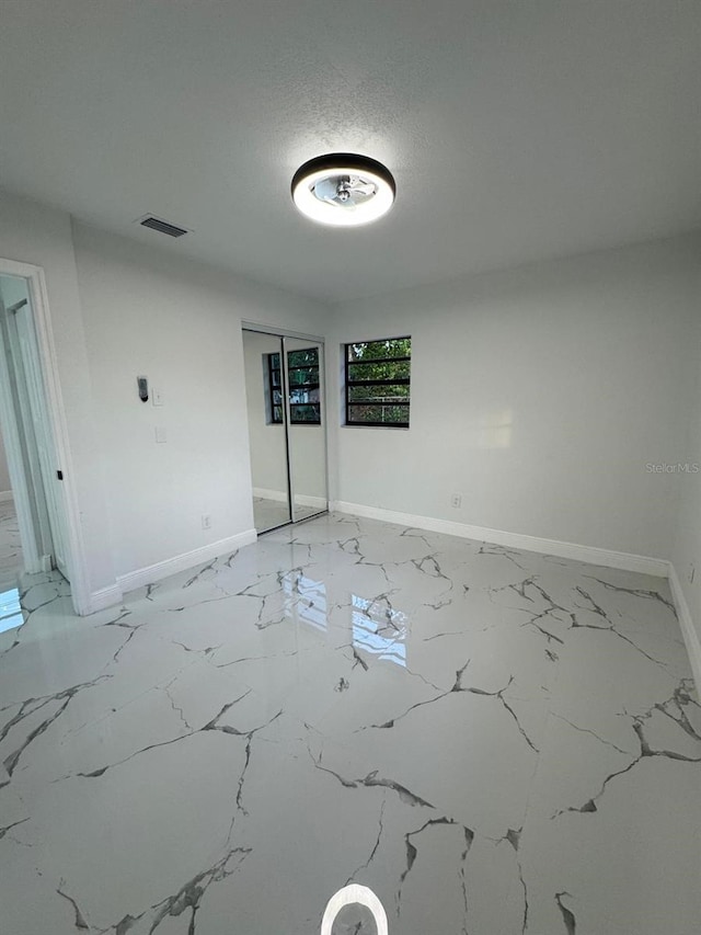 empty room featuring a textured ceiling