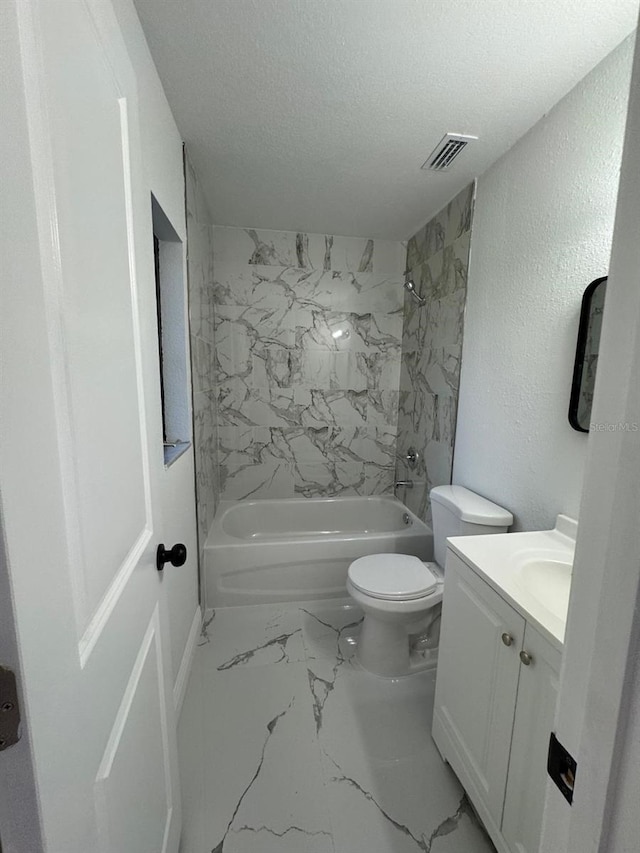 full bathroom featuring vanity, a textured ceiling, toilet, and tiled shower / bath