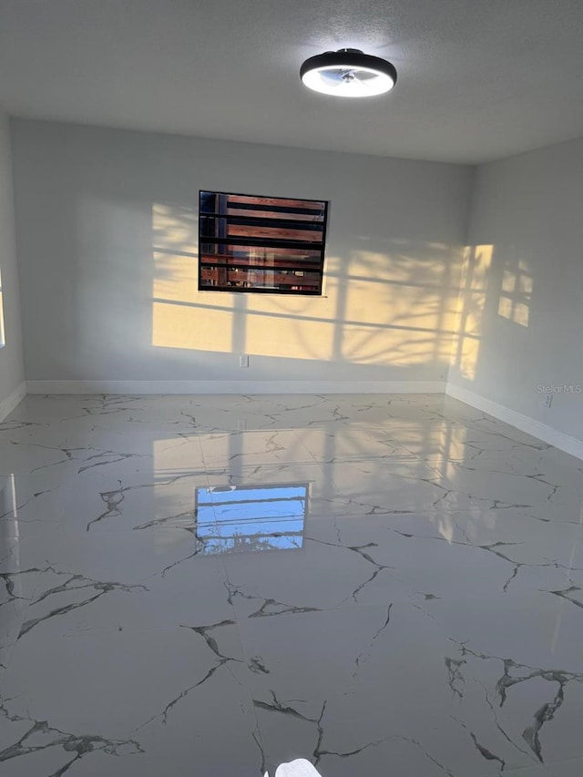 unfurnished room with a textured ceiling