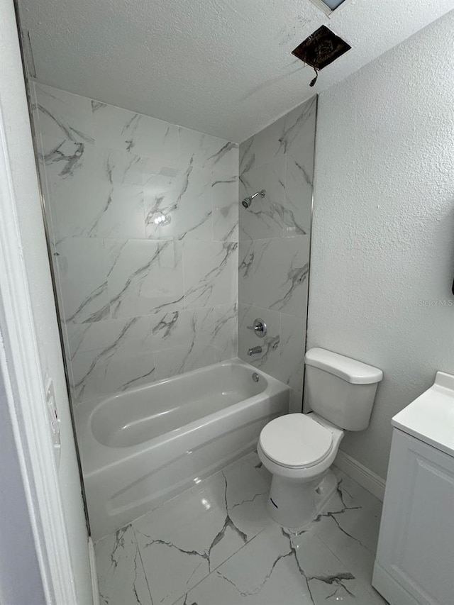 full bathroom featuring vanity, a textured ceiling, tiled shower / bath combo, and toilet