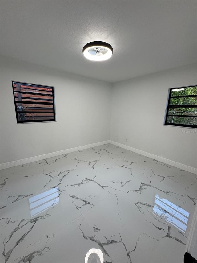 empty room featuring a textured ceiling