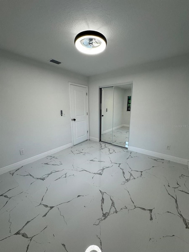 spare room with a textured ceiling