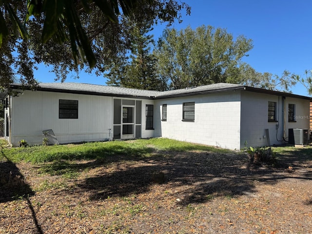 rear view of house featuring central air condition unit