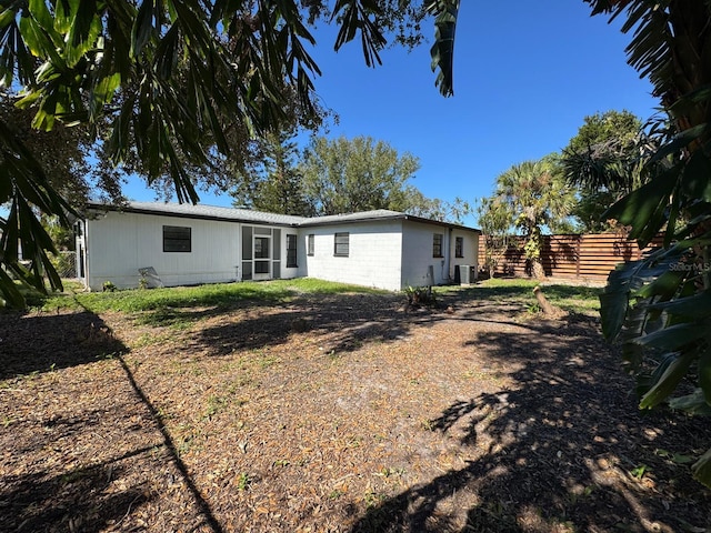 rear view of property featuring central AC unit