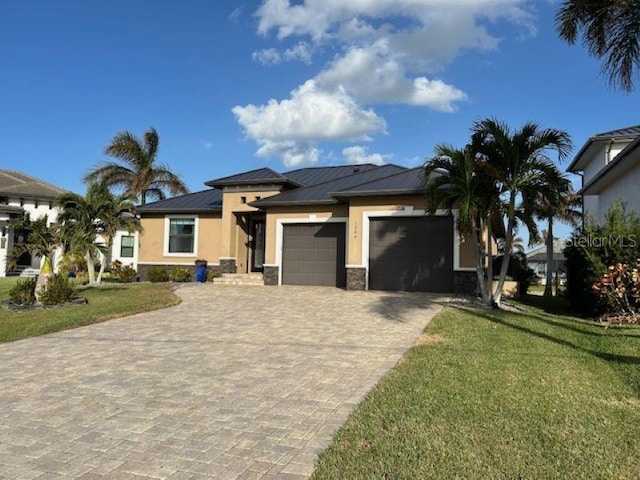 view of front of house with a garage and a front lawn