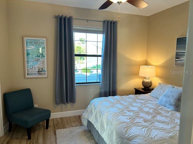 bedroom with hardwood / wood-style flooring and ceiling fan