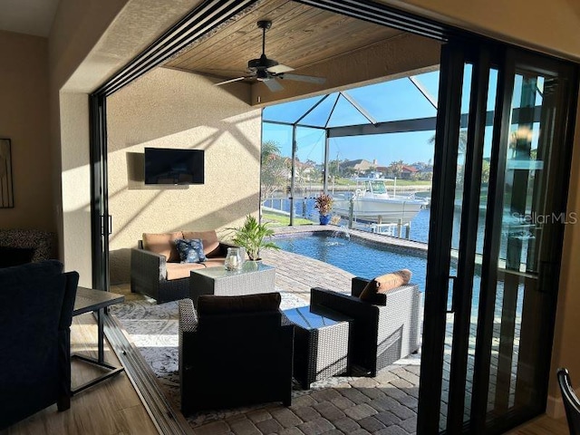 view of patio with an outdoor hangout area, pool water feature, ceiling fan, and a lanai