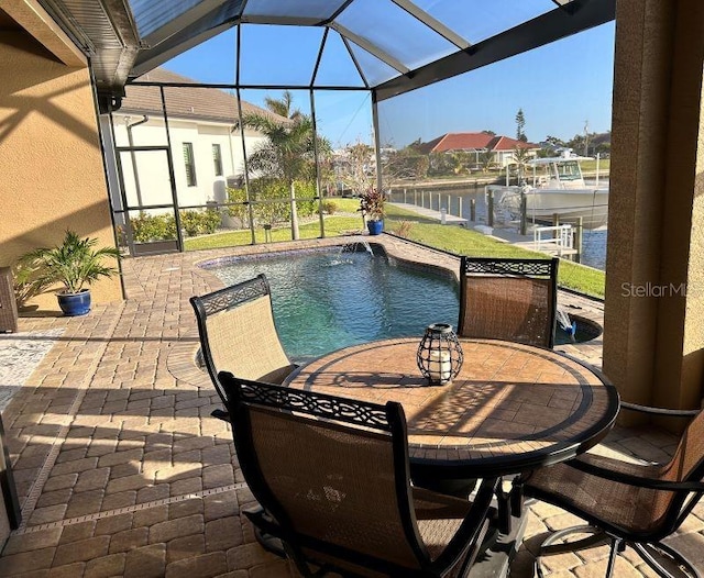 view of pool featuring a water view, a patio, and glass enclosure