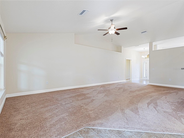 spare room with ceiling fan, lofted ceiling, and carpet floors