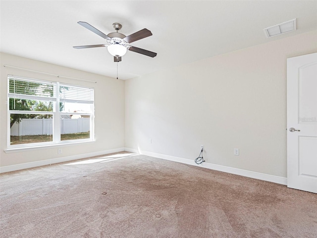 empty room featuring carpet flooring and ceiling fan