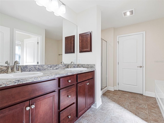 bathroom with shower with separate bathtub, vanity, and tile patterned flooring