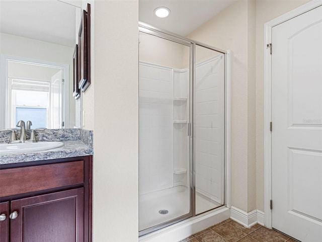 bathroom with vanity, tile patterned floors, and a shower with door