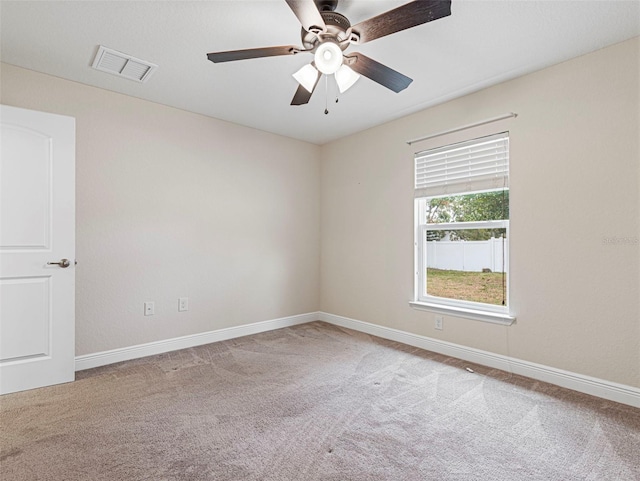 carpeted spare room featuring ceiling fan