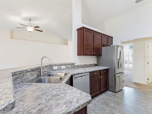 kitchen with stainless steel appliances, dark brown cabinets, sink, and lofted ceiling