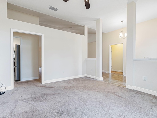 unfurnished room featuring light colored carpet and ceiling fan