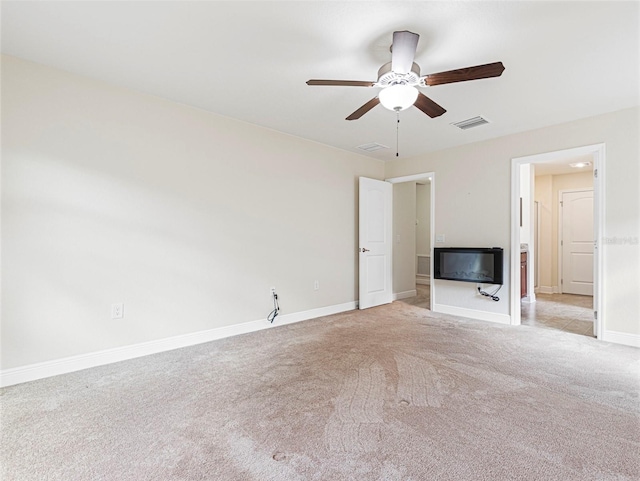 unfurnished living room featuring light colored carpet and ceiling fan