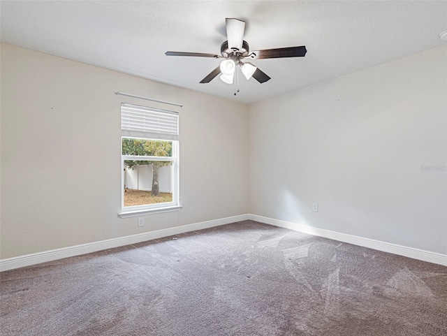 empty room featuring ceiling fan and carpet floors