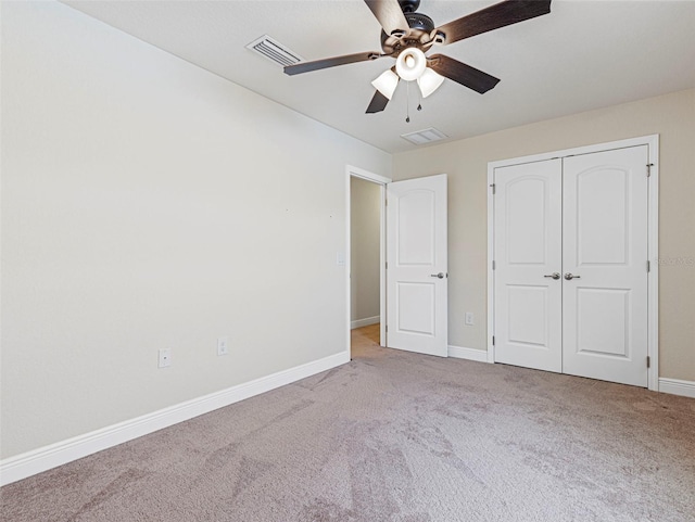 unfurnished bedroom with a closet, light carpet, and ceiling fan