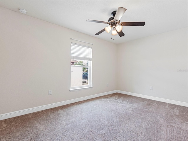 spare room with ceiling fan and carpet flooring