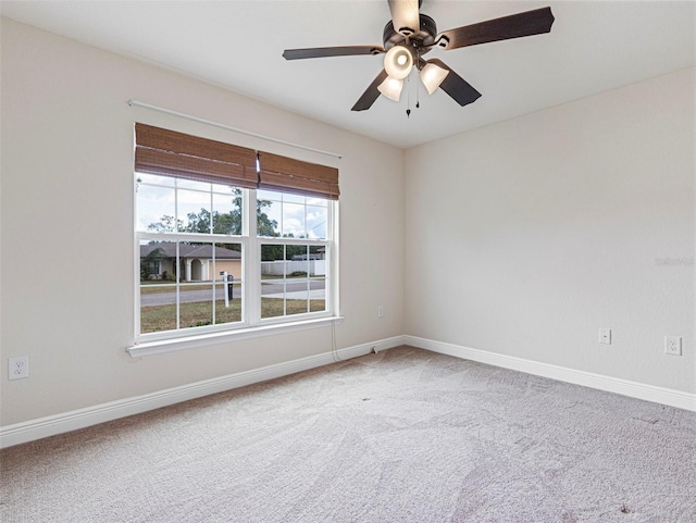 unfurnished room with ceiling fan and carpet floors