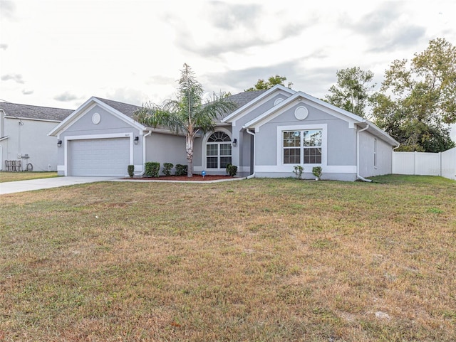 single story home featuring a garage and a front lawn