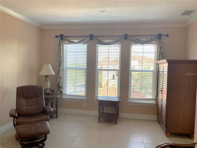 sitting room featuring ornamental molding, light tile patterned flooring, and a wealth of natural light