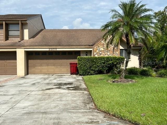 view of front facade featuring a front lawn and a garage