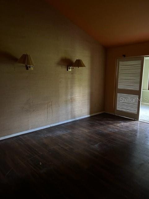 empty room with dark hardwood / wood-style floors