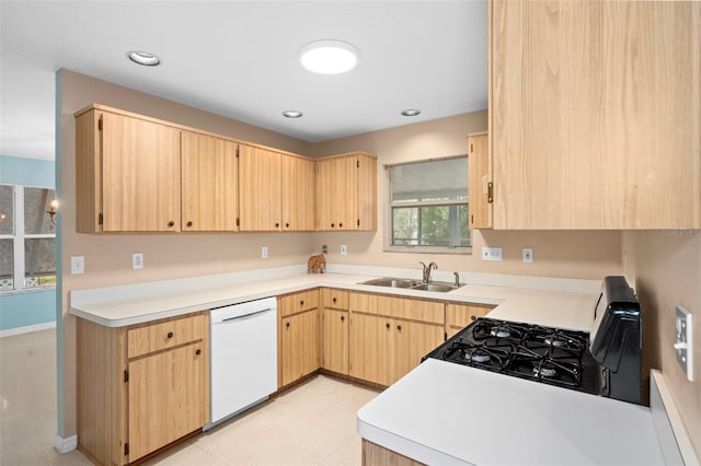 kitchen with white dishwasher, sink, light brown cabinets, and black gas range