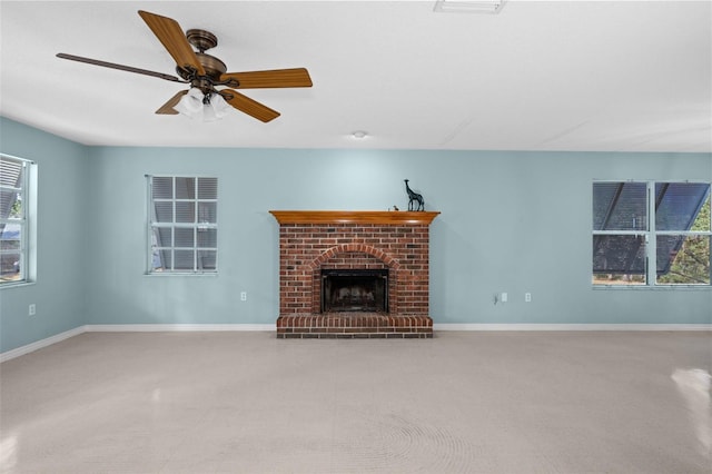 unfurnished living room with ceiling fan and a brick fireplace