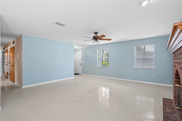 unfurnished living room featuring a fireplace and ceiling fan