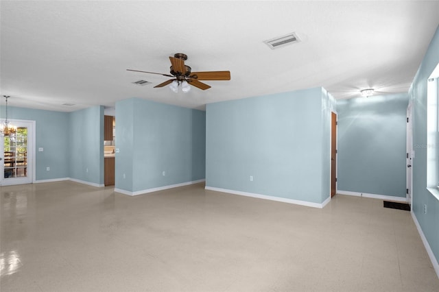 empty room with a textured ceiling and ceiling fan with notable chandelier