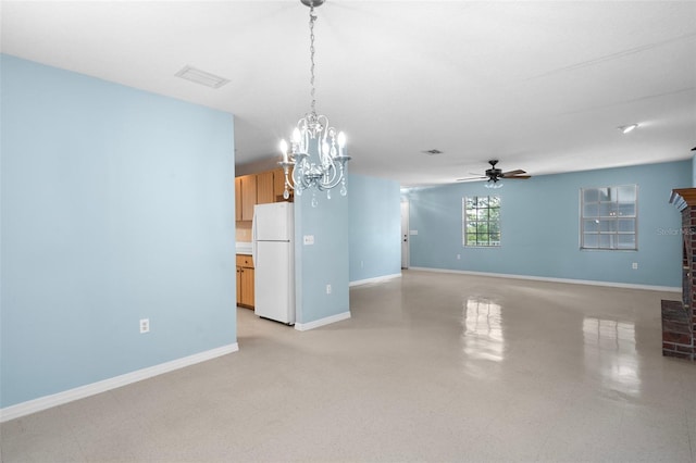 unfurnished living room featuring a brick fireplace and ceiling fan with notable chandelier