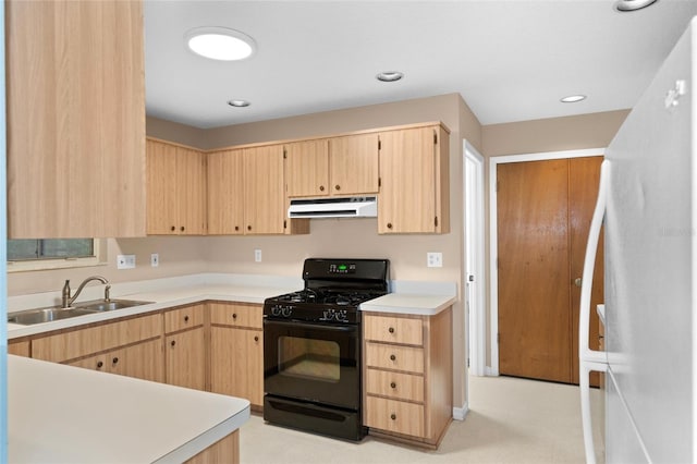 kitchen featuring sink, light brown cabinets, white fridge, and black gas range oven