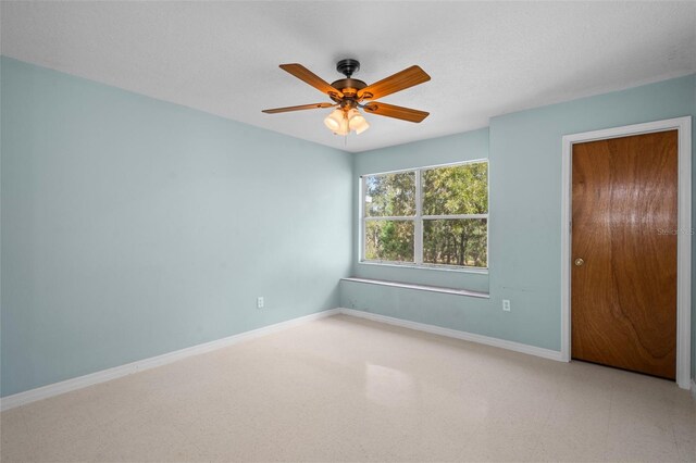 spare room featuring a textured ceiling and ceiling fan