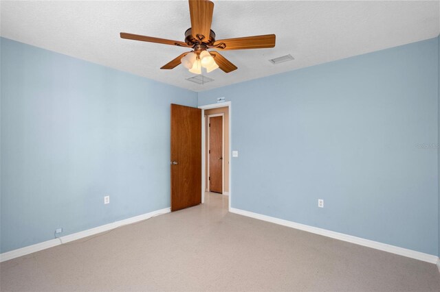 unfurnished room featuring ceiling fan and a textured ceiling