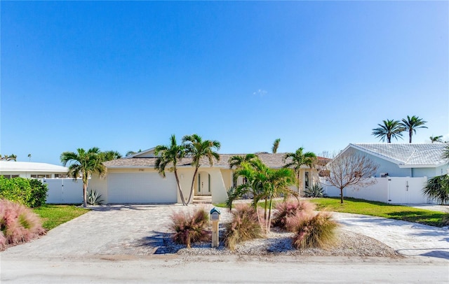 view of front of home with a garage and a front lawn