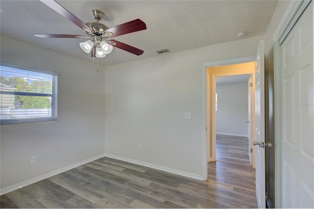 unfurnished room featuring a textured ceiling, hardwood / wood-style flooring, and ceiling fan