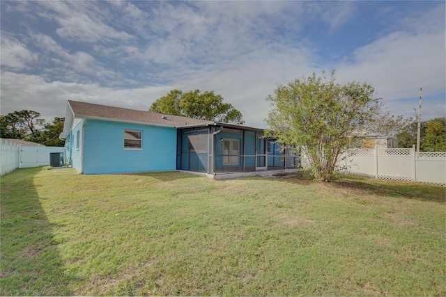 back of property with a lawn and central air condition unit