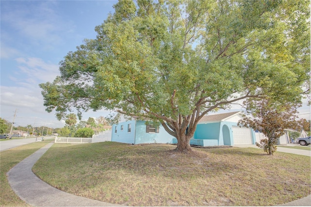 view of side of home featuring a garage and a yard