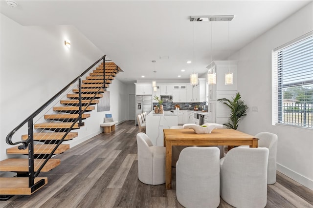 dining space with sink and dark hardwood / wood-style flooring