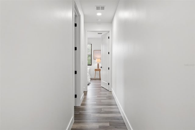 hall with hardwood / wood-style floors